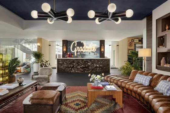 Lobby with leather seating and a Graduate by Hilton sign