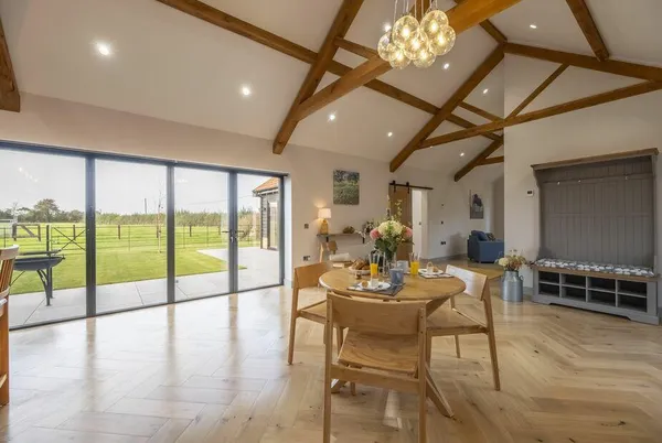 The Milking Parlour courtyard with outdoor dining and countryside beyond