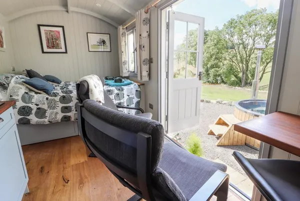 The Moorhen Retreat compact interior with doors open to the view