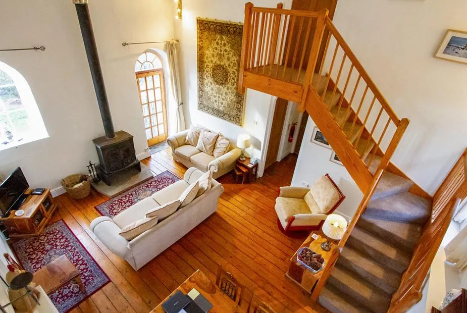 The Old Chapel double-height living room with staircase