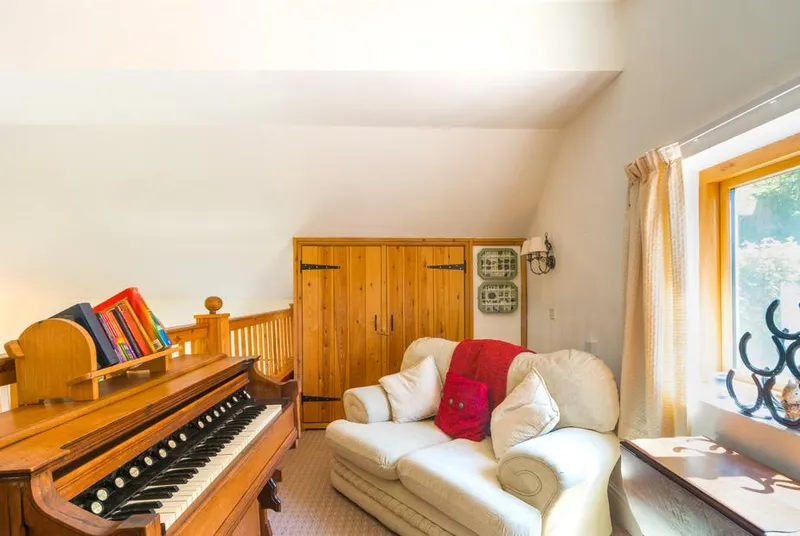 The Old Chapel music room with organ and bench seating