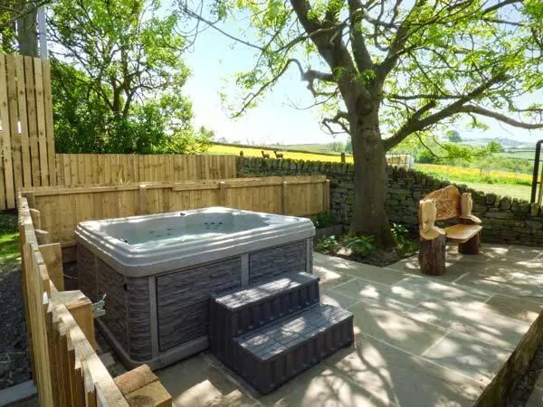 The Old Corn Store slate-clad hot tub with moorland views