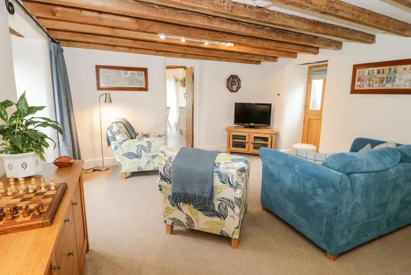 The Old Stable lounge with blue sofas and beams