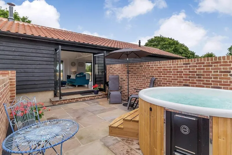 The Old Workshop private patio hot tub with wide countryside views