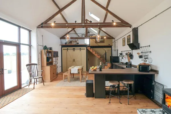 The Old Workshop open-plan barn interior with vaulted beams and mezzanine