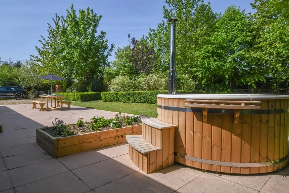 The Piglets wood-fired hot tub on the patio