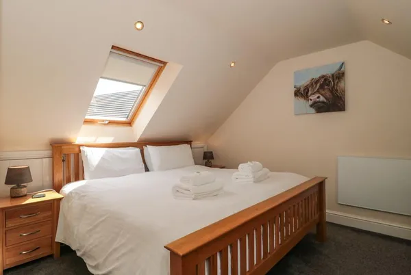 The Retreat super-king bedroom with Velux window and oak furniture