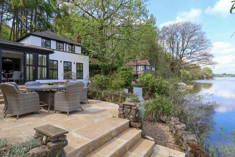 The Sheiling lakeside exterior with stone patio and Rudyard Lake