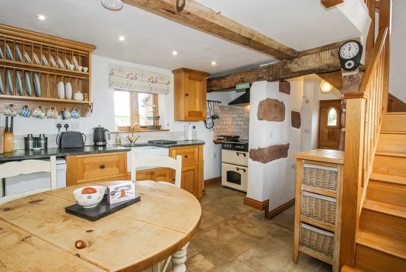 The Shooting Folly rustic kitchen with beams and stonework