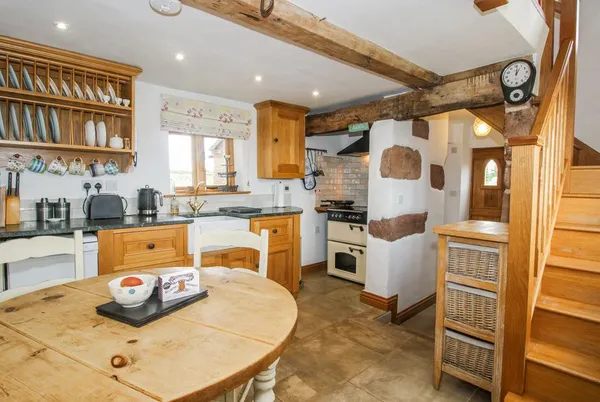 The Shooting Folly rustic kitchen with beams and stonework