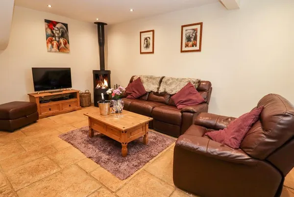 The Stables lounge with log burner and leather sofas
