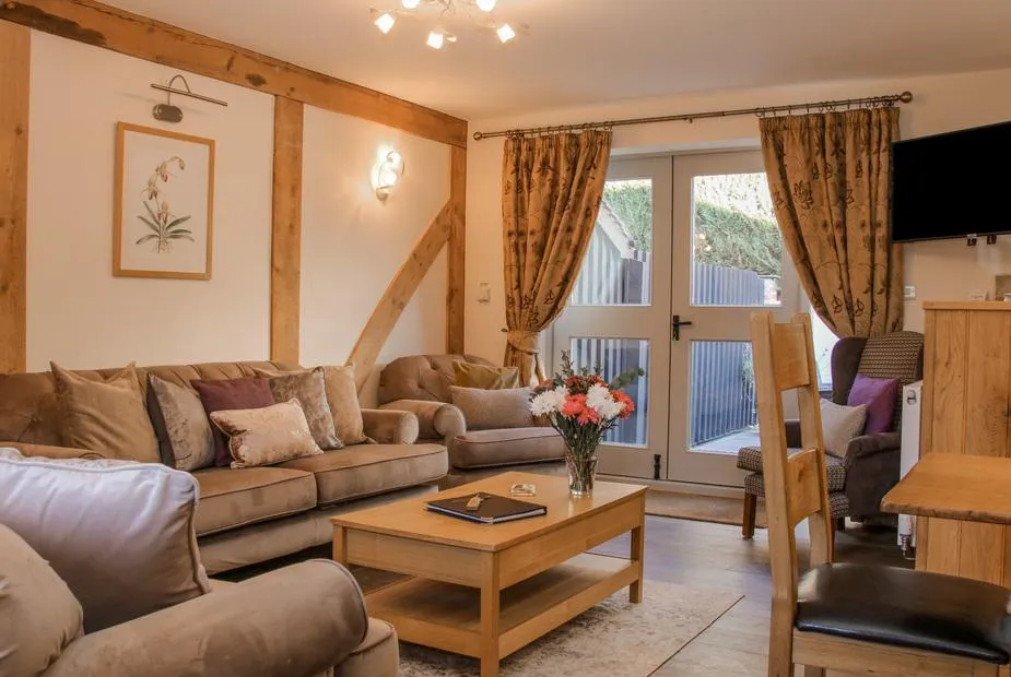 The Turnip House living room with beams and soft seating