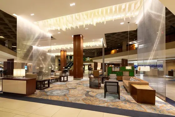 Lobby of a hotel with couches and tables