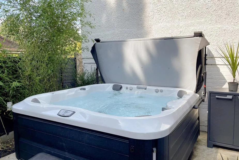 The White House Retreat large hot tub with bubbling water and greenery