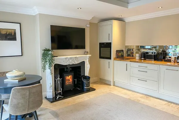 The White House Retreat open-plan kitchen-living with marble woodburner