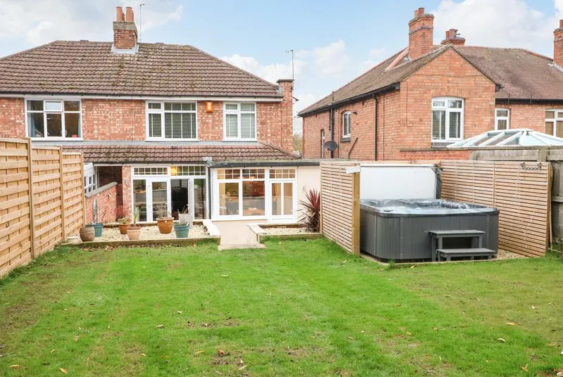The Willows rear garden with hot tub and full back elevation