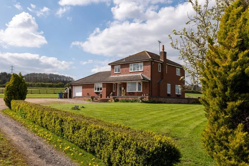 Tixall Manor Farm red brick farmhouse with lawn and countryside