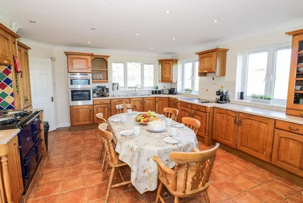 Tixall Manor Farm kitchen-diner with blue Aga and oak cabinets