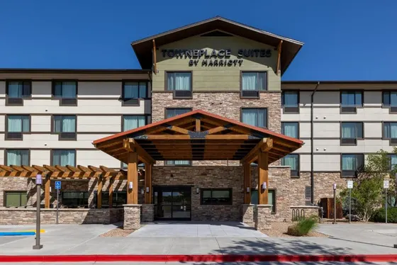 Wooden covered entrance with stone pillars and a TownePlace Suites sign