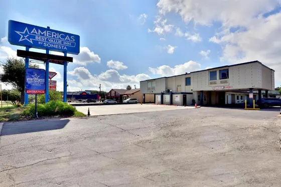 Beige motel with a tall Americas Best Value Inn sign