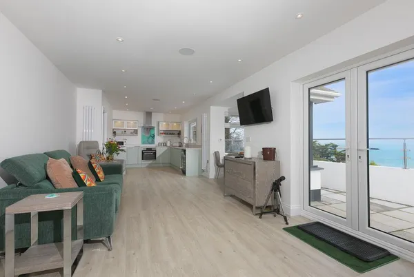Tresco Bungalow open-plan living area opening to the sea-view terrace