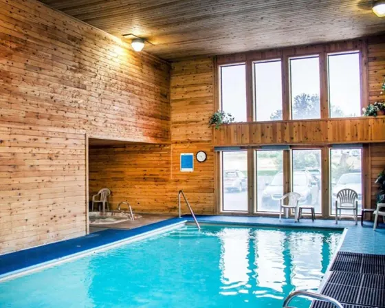 Swimming pool in a room with a brick wall