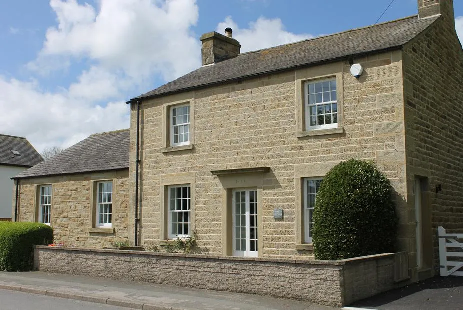 Vine Cottage stone cottage frontage on a village street