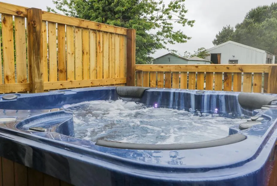 Wagtail Nest bubbling hot tub with LED lights in cottage garden