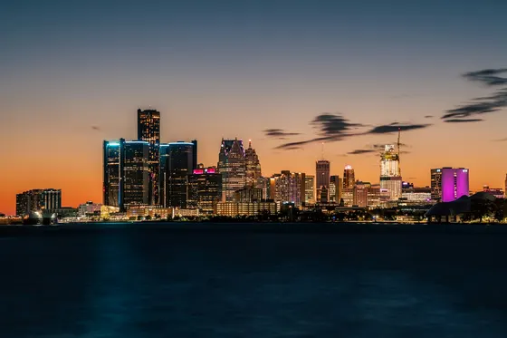 Detroit skyline lit at dusk across the river