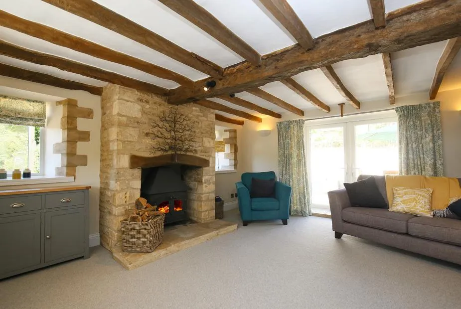 Washpool lounge with stone fireplace and beamed ceiling