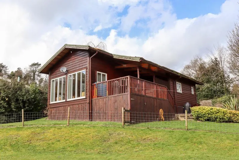 Watersview Lodge full exterior from lawn in landscape setting