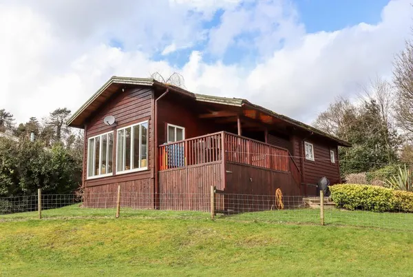 Watersview Lodge full exterior from lawn in landscape setting