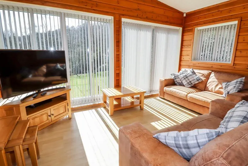 Watersview Lodge living room with warm pine walls and natural sunlight