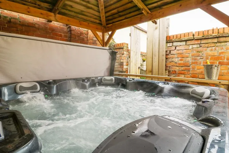 Well Cottage hot tub under wooden gazebo