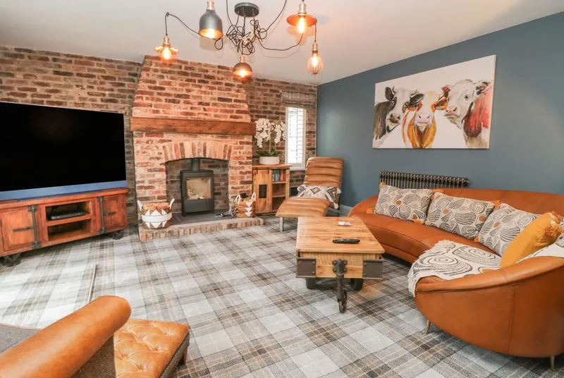 Well Cottage living room with exposed brick fireplace and wood burner