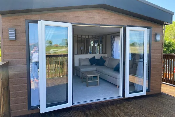 Willow Lodge facade with bi-fold doors open to living room
