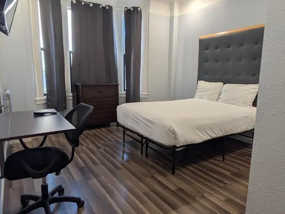 Bedroom with a bed and a desk and a chair