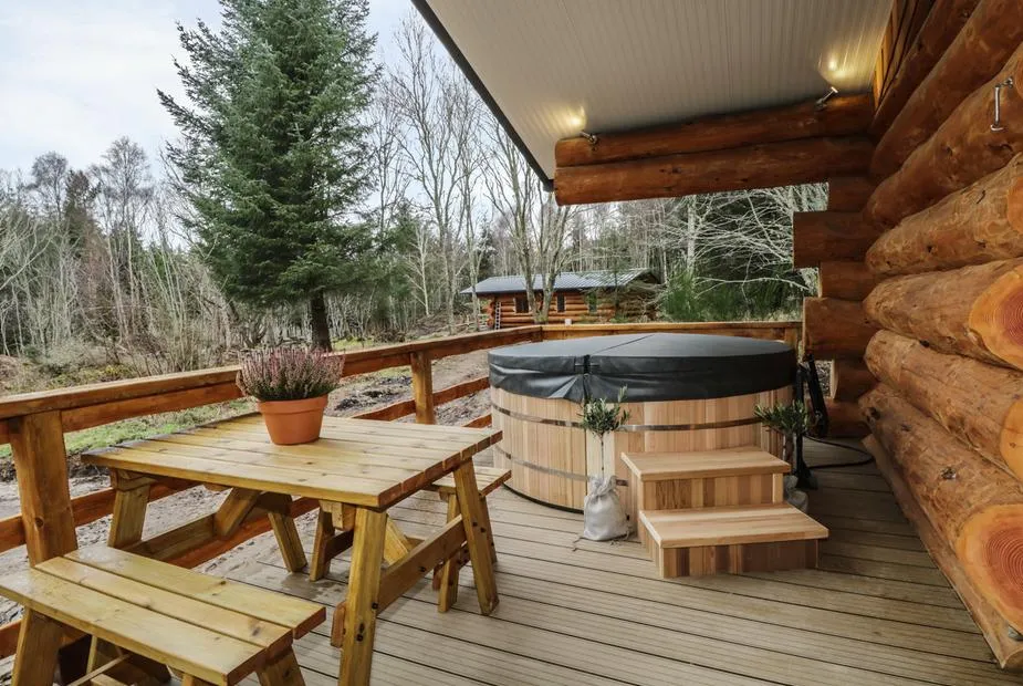 Moorhen Lodge hot tub on a covered deck in woodland