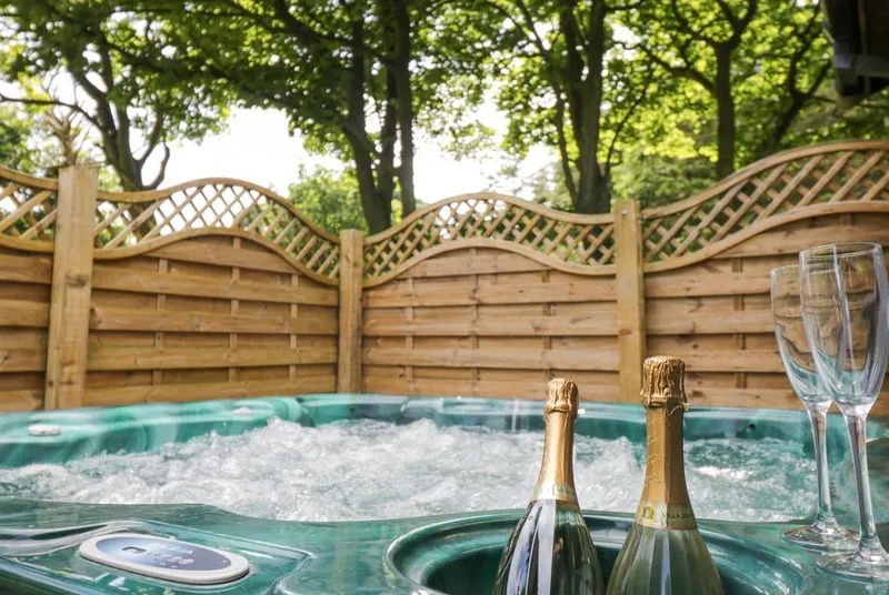 Pond Farm Woodlands hot tub with champagne glasses