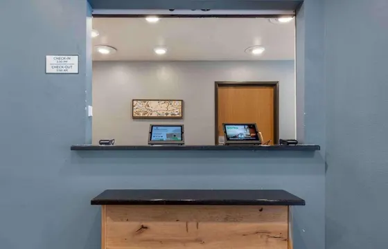 Blue check-in window with tablets and an Austin map