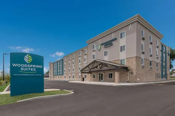 Rendering of a building with a sign in front of it