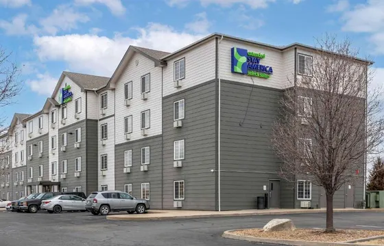 Large building with cars parked in a parking lot
