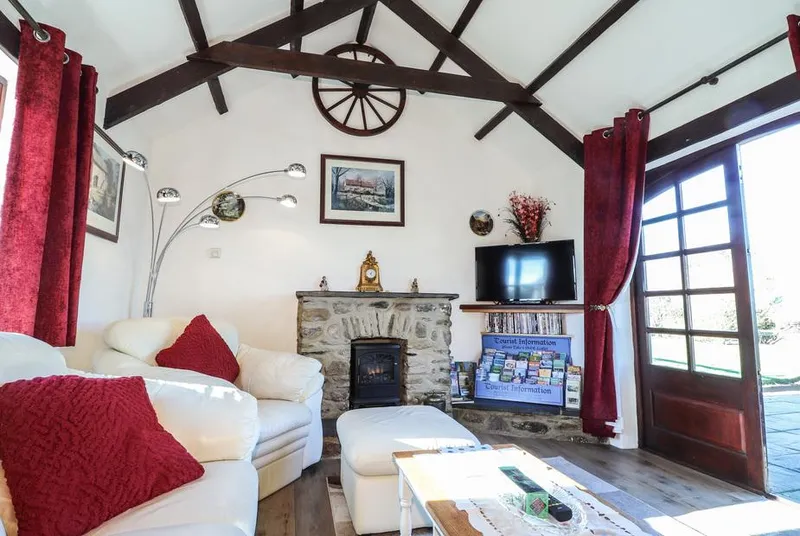 Y Stabl vaulted lounge with stone fireplace and French doors