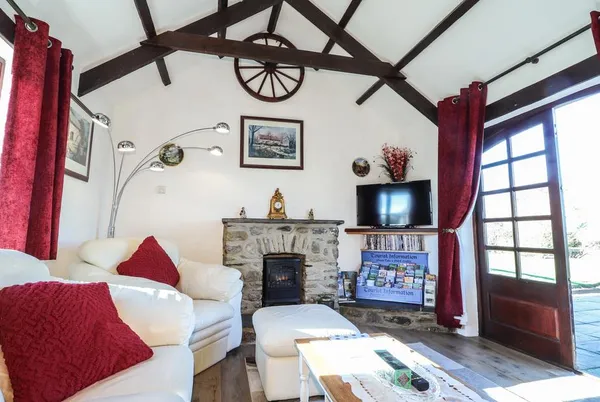 Y Stabl vaulted lounge with stone fireplace and French doors