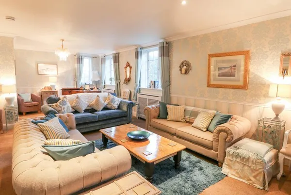 Yardley Manor spacious lounge with blue and cream sofas