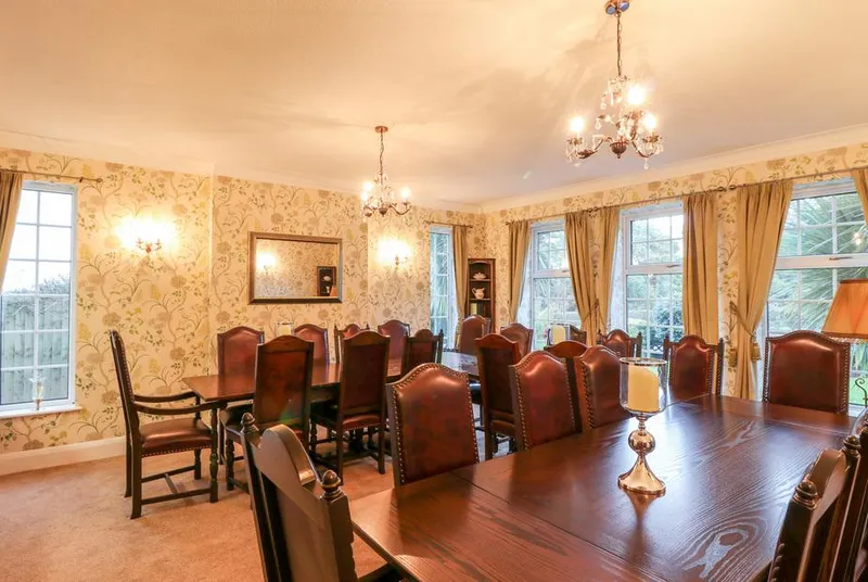 Yardley Manor formal dining room with dark wood table and chandelier